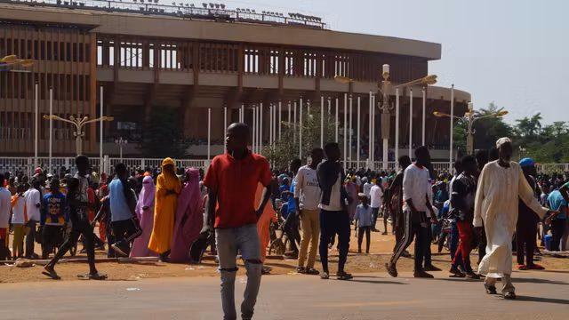 Nigerien volunteers gather near Niamey’s General Seyni Kountché Stadium for recruitment during a civilian militia formation session on August 19, 2023.