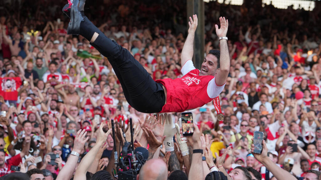 Arsenal manager Mikel Arteta carried in triumph by players celebrating their Premier League title after the match between Crystal Palace and Arsenal in London, England, Sunday 24 May 2026.