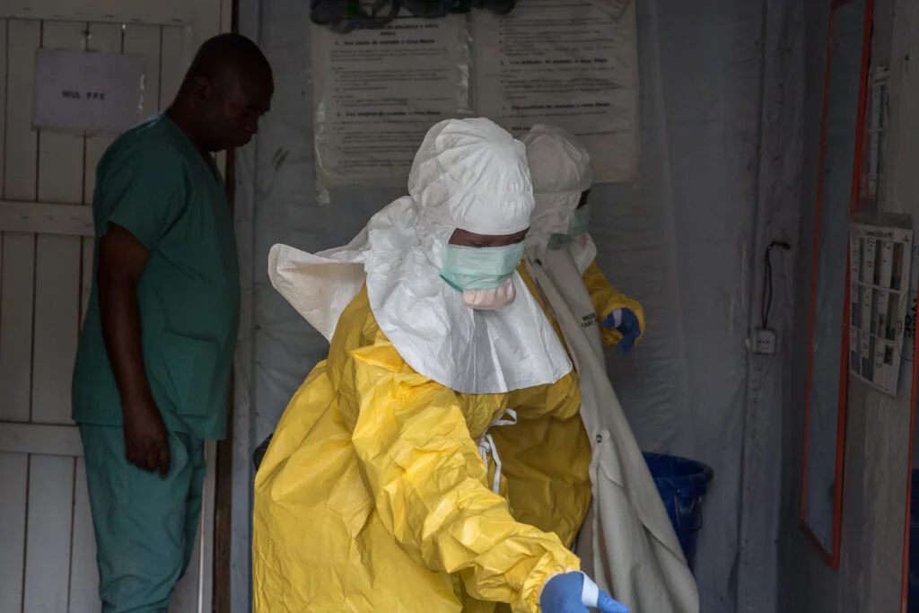 Health workers in protective gear administering care in eastern Democratic Republic of Congo