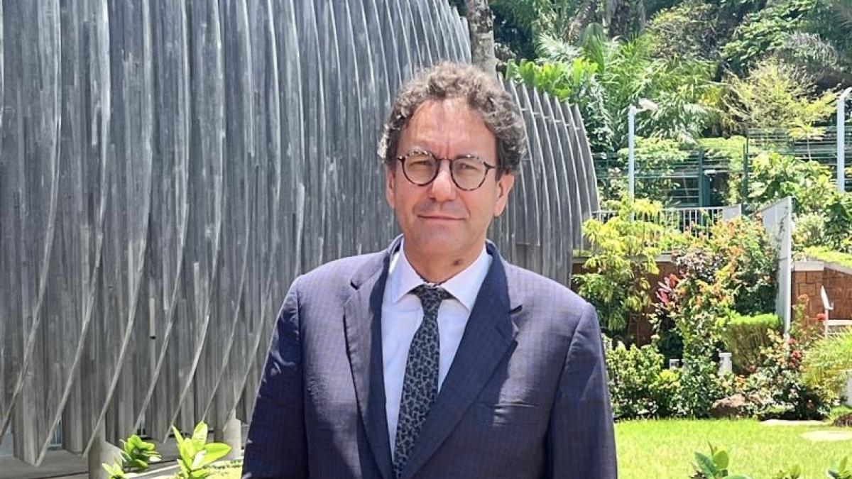 Ambassador Fabrice Mauriès speaking at a podium in Libreville