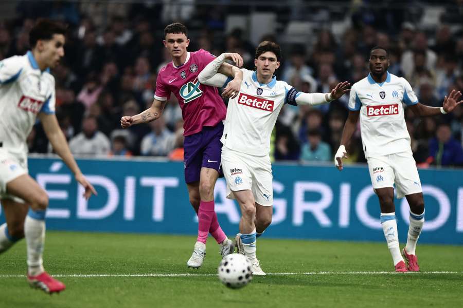 Rasmus Nicolaisen challenges Leonardo Balerdi during the Coupe de France quarter-final between Marseille and Toulouse on March 4, 2026, at the Vélodrome
